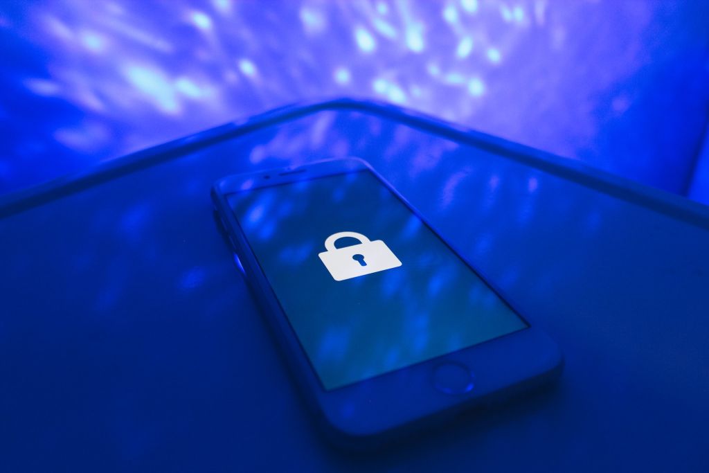 Cellphone with a lock symbol on the screen lying on a table